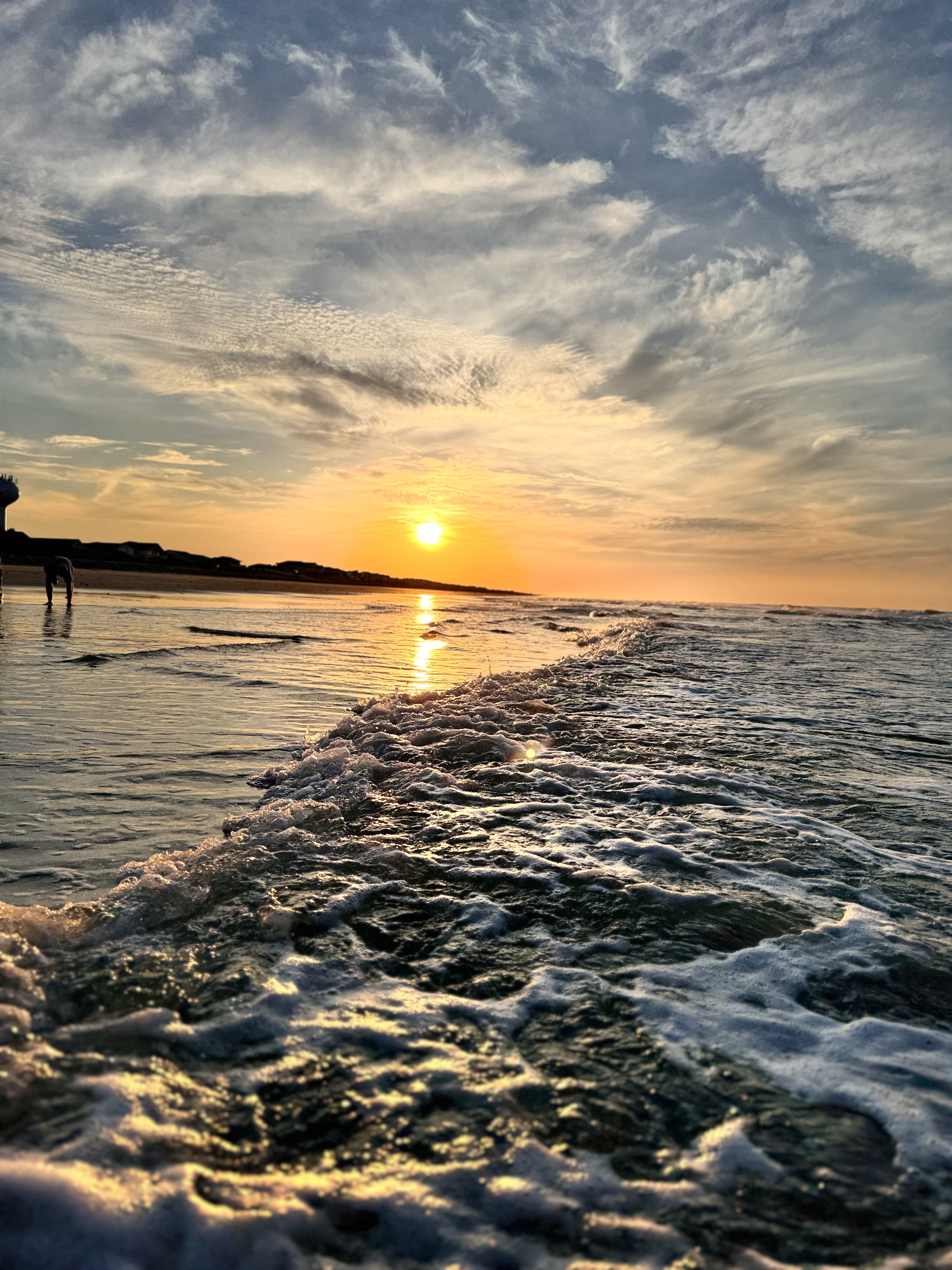 Waves crashing at sunrise on the beach